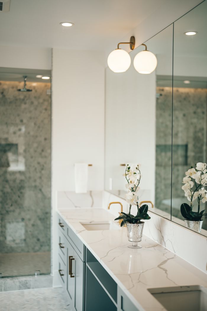 Home Luxurious bathroom featuring marble countertops, gold fixtures, and a stylish mirror. Perfect for home decor inspiration.