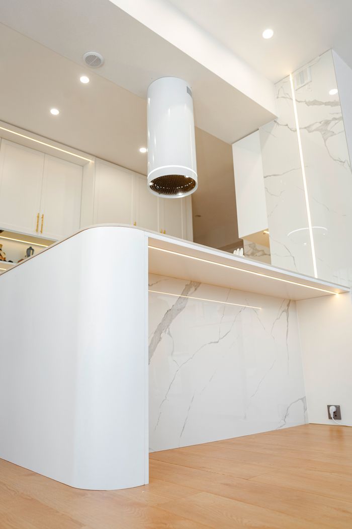 Services Sleek kitchen design featuring white marble countertops and modern fixtures.